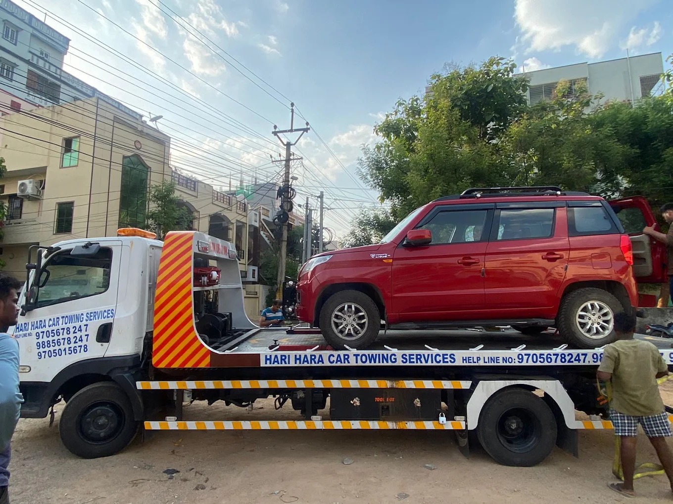 Flatbed towing truck transporting a vehicle